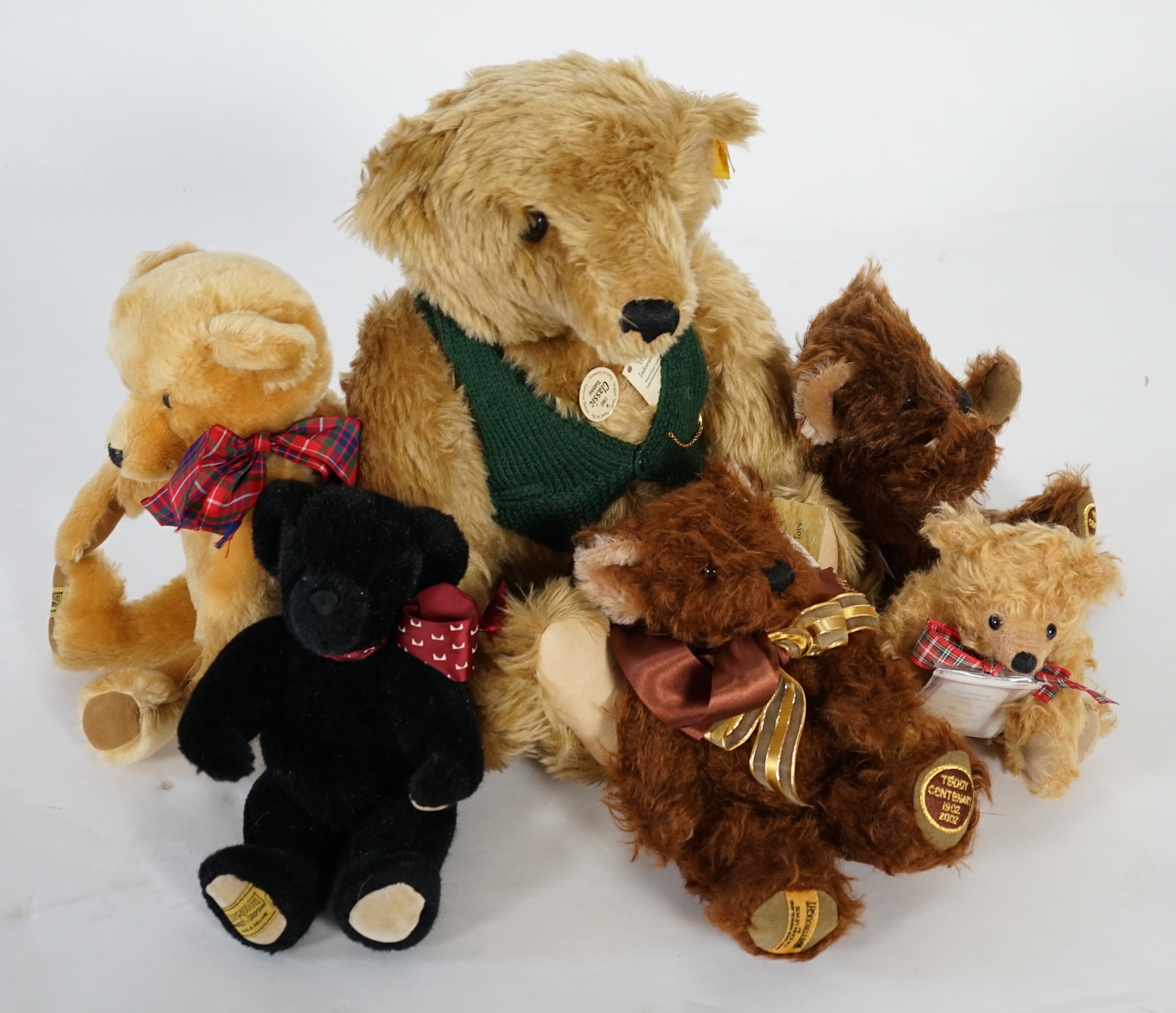 A large 1906 Steiff orange label, two Merrythought John Lewis bears, a black Merrythought bear, an artist bear and a Merrythought Alfred bear (6)
